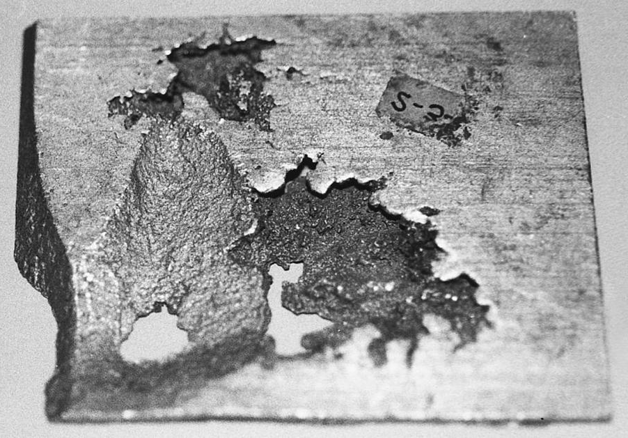 Typical shrink porosity shape shown here in a sand casting because the large porosity here shows the structure clearly (1X).