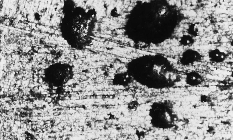 Some typical trapped gas porosity, showing the shiny walls, as well as, shinny walls and a wall that is sometimes smooth and sometimes rough, due to oxide (10X).
